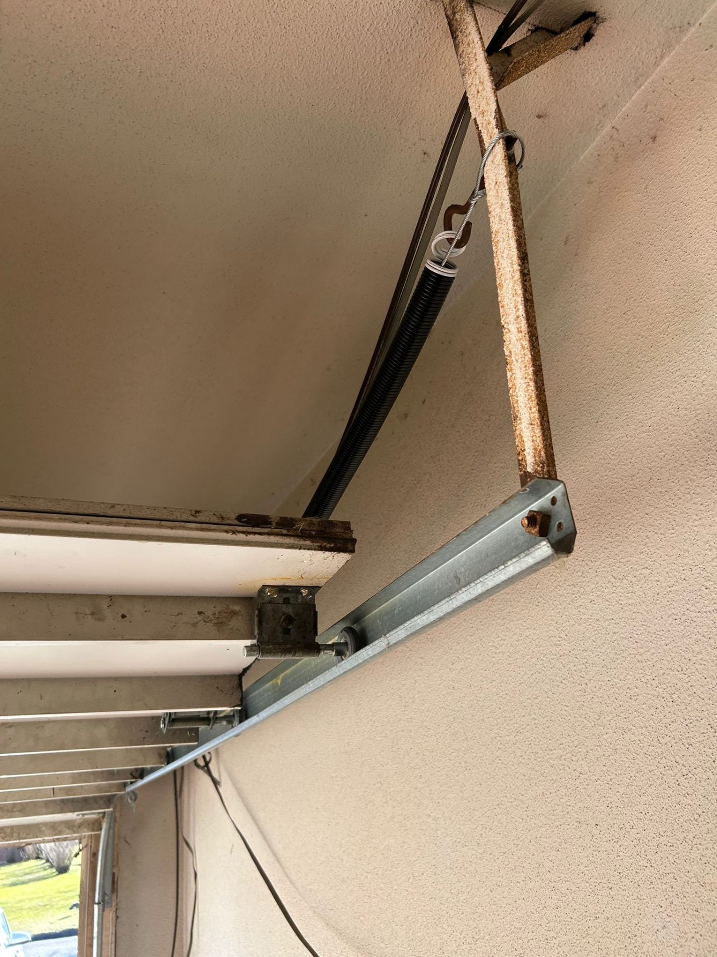 Cable, drum and bracket service on a residential garage door